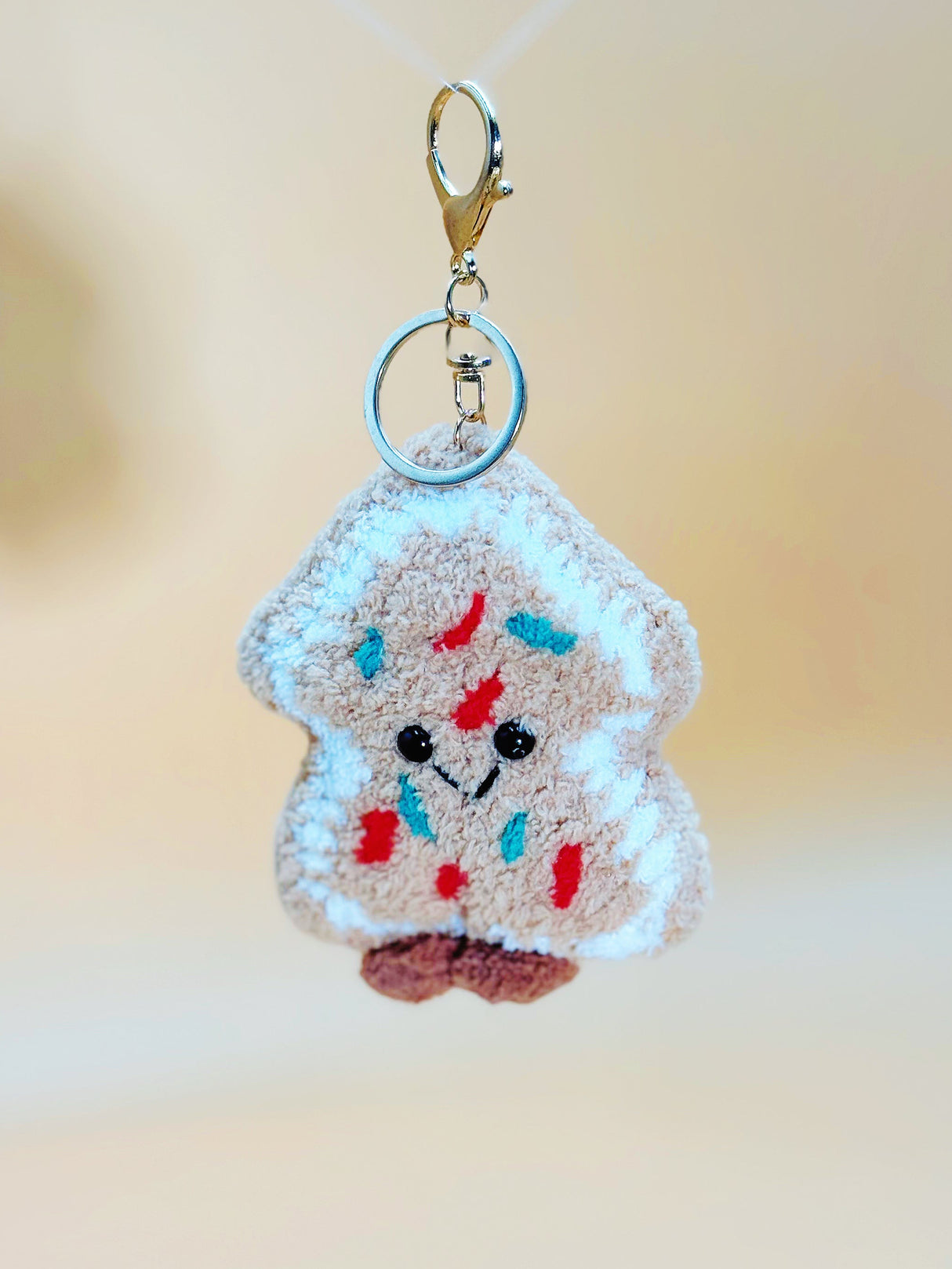Keychain shaped like a piece of cookie with colorful spread on a blurred background