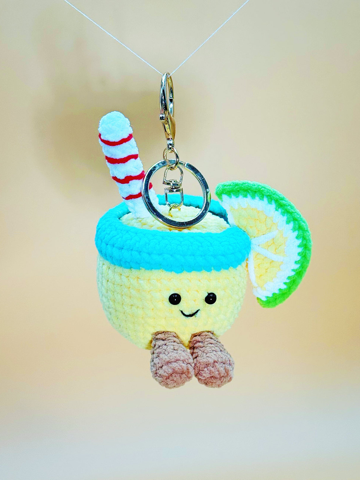 Keychain with a lemon character design on a plain background