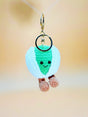 Crocheted keychain with a smiling face on a blurred background