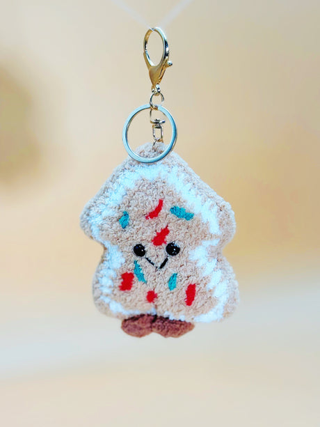 Keychain shaped like a piece of cookie with colorful spread on a blurred background