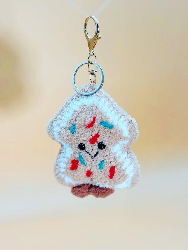 Keychain shaped like a piece of cookie with colorful spread on a blurred background